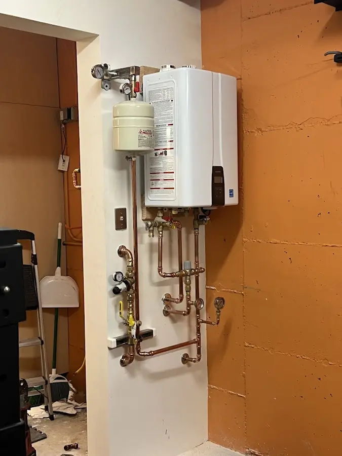 Plumbing technician inspecting water heater connections in Sylacauga